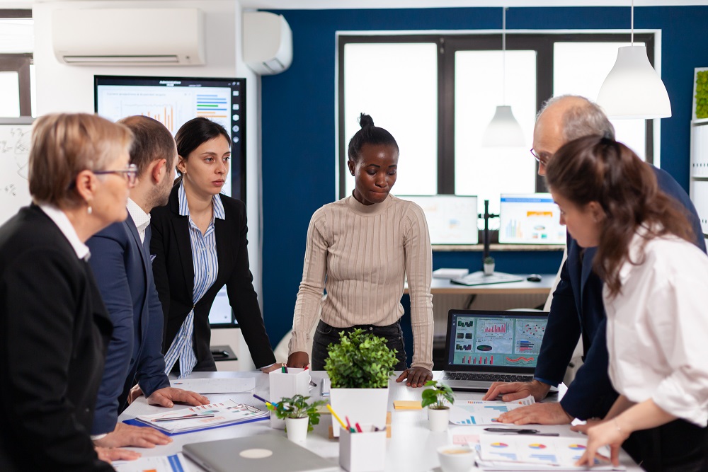 Diverse colleagues businesspeople discussing company issue Diverse colleagues discussing to implement automation tools