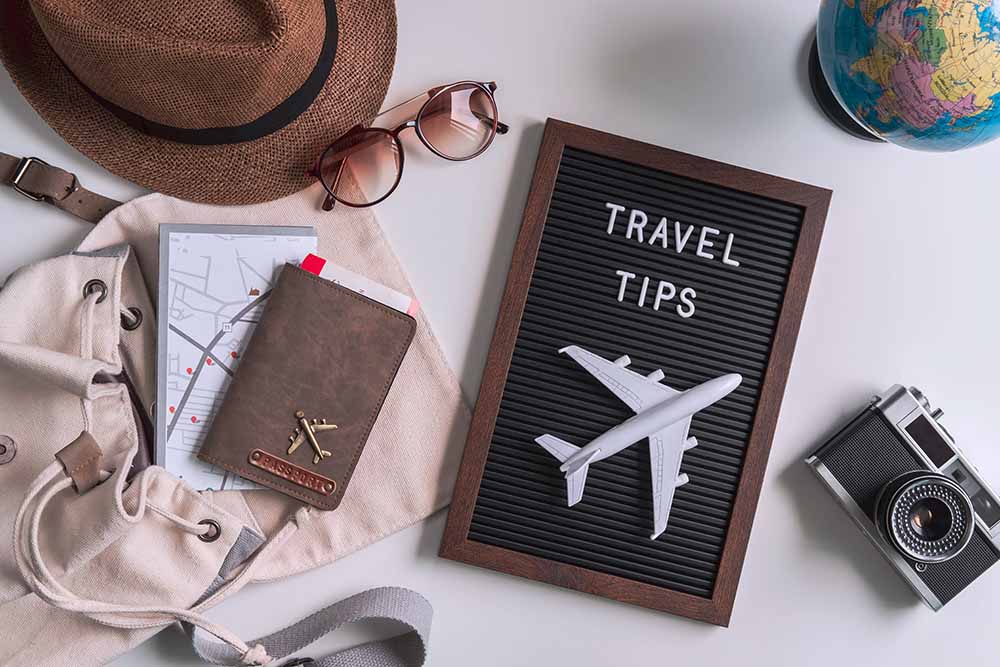 Retro camera with toy plane, map and passport on white background, Travel tips concept business travel tips