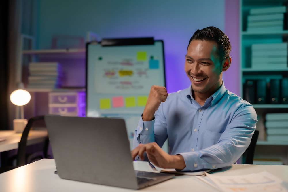 Achievement Unlocked. Asian Businessman Raises Arms in Triumph a all-in-one