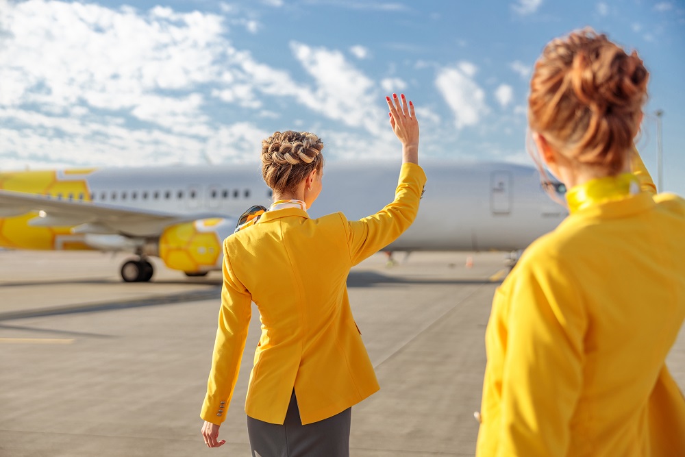 Flight attendants greeting passenger airplane at airfield vueling low cost airlines
europe