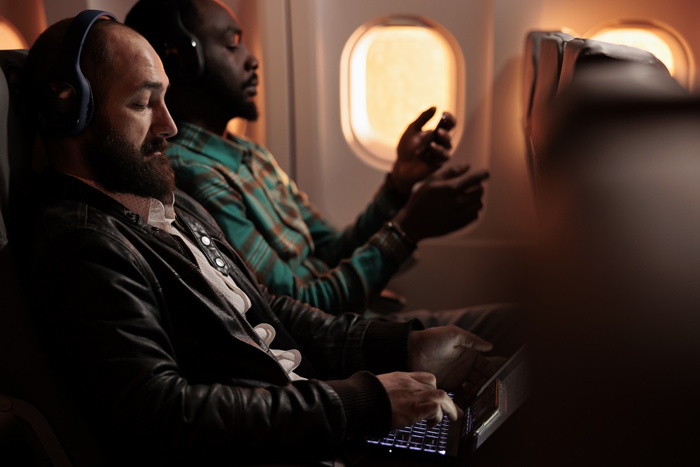 Multiethnic group of people flying in economy class on plane jet economy class seating