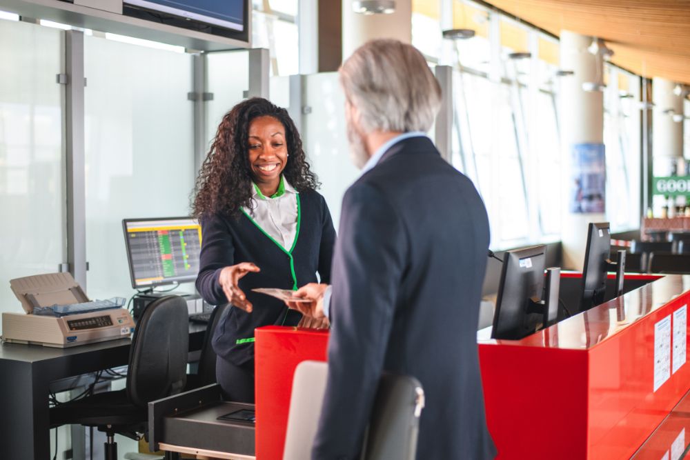 frequent-flyer Woman working at airport collecting boarding pass from business traveler