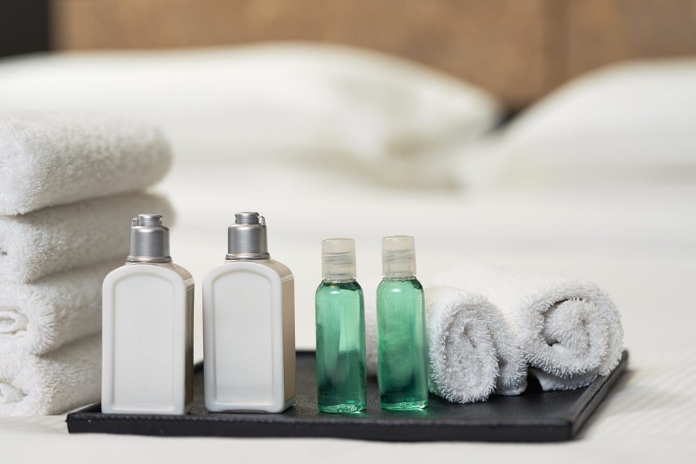 Bed with fresh towels and amenities in hotel hotel shampoo amenities