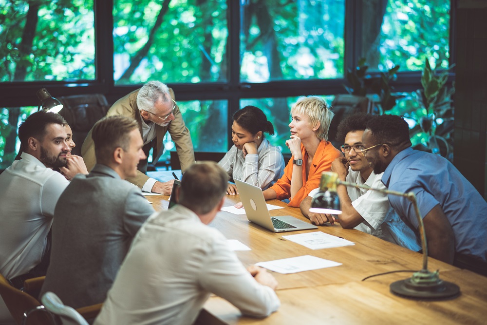 cinematic image of people working in a start up business. colleagues in a meeting room surrounded by trees