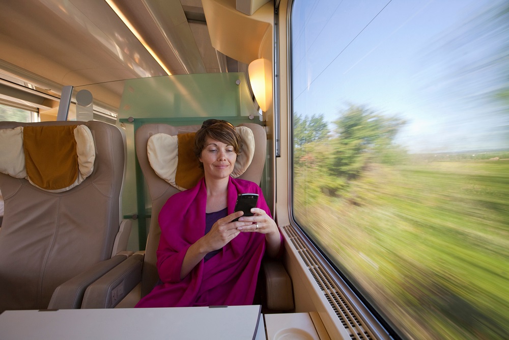 A woman on train sustainable business travel