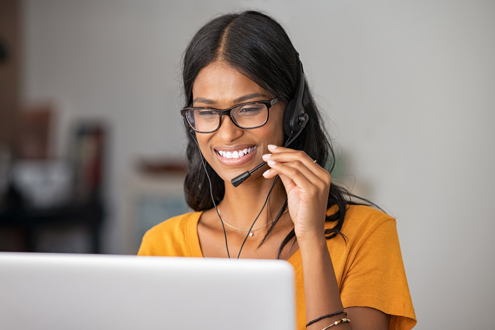 Cheerful,Indian,Woman,In,Smart,Working,From,Home.,Happy,Middle Agent on the phone with laptop
