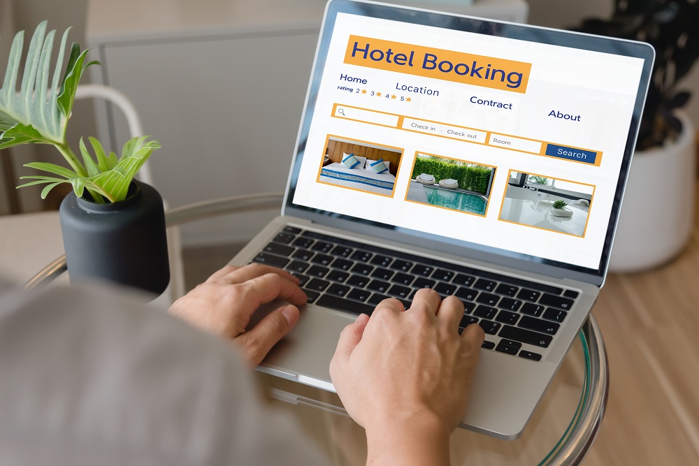 booking online concept, person using laptop computer planning travel search hotel booking. online booking tool